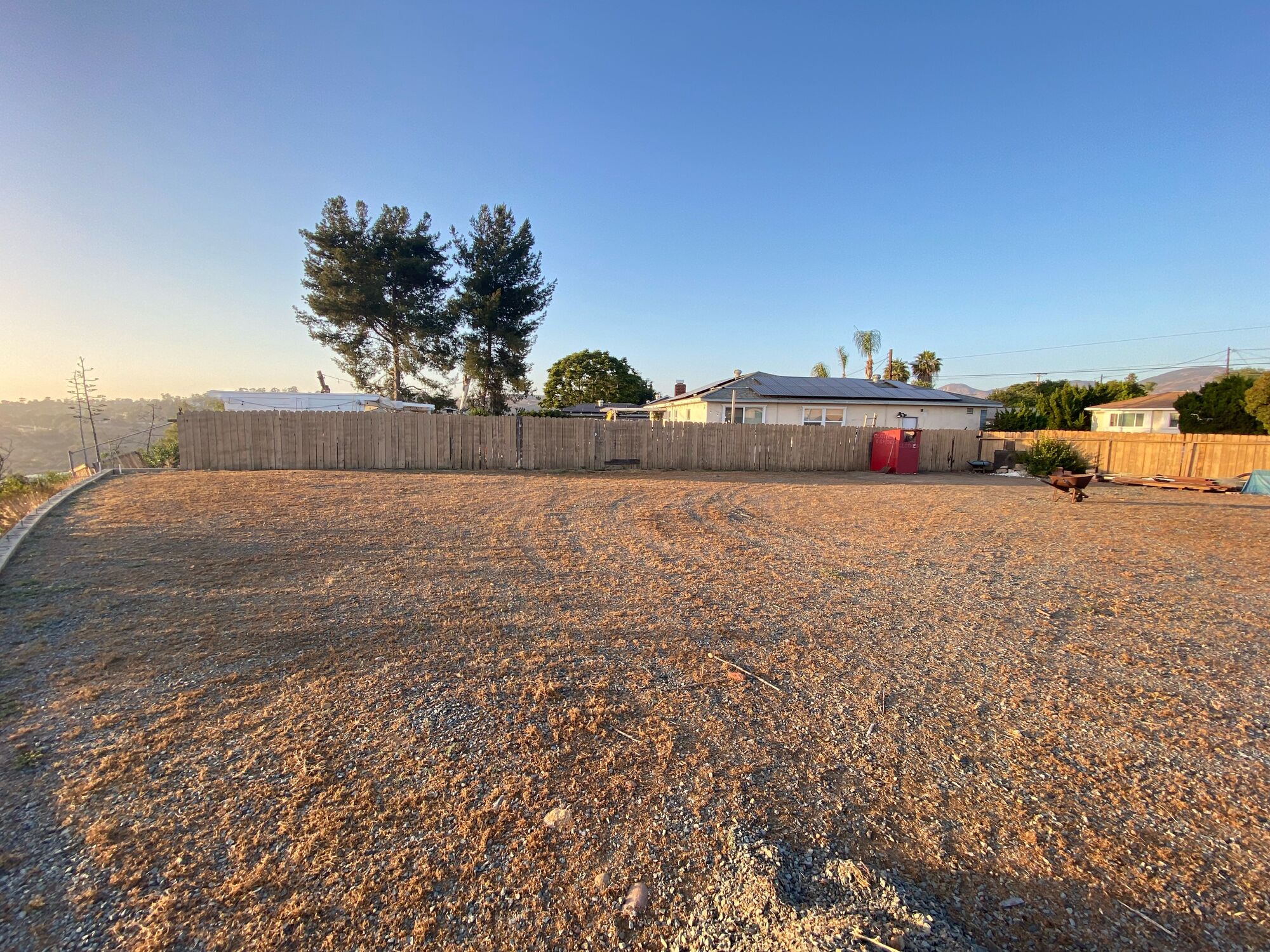 The pilot site before work began: a bare gravel lot in full sun.